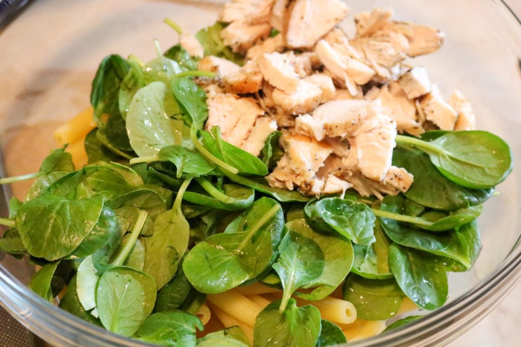 Mix greens, chicken, and pasta