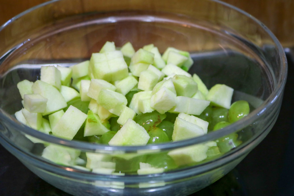 Add apples, walnuts, grapes, salt, and yogurt