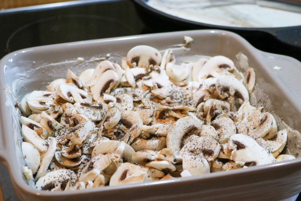 Place mushrooms into the baking dish